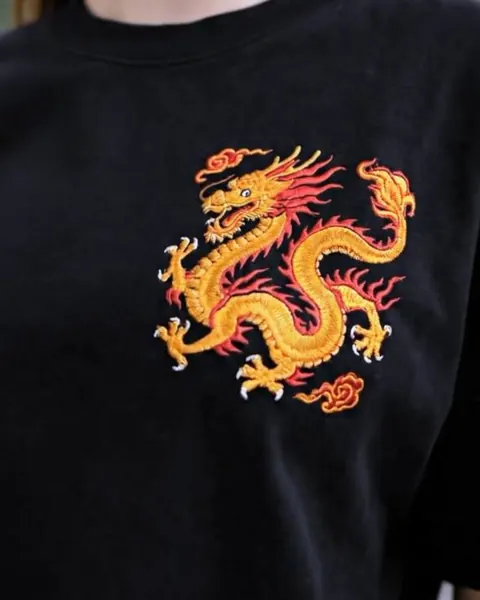 Golden dragon embroidered on a black t-shirt