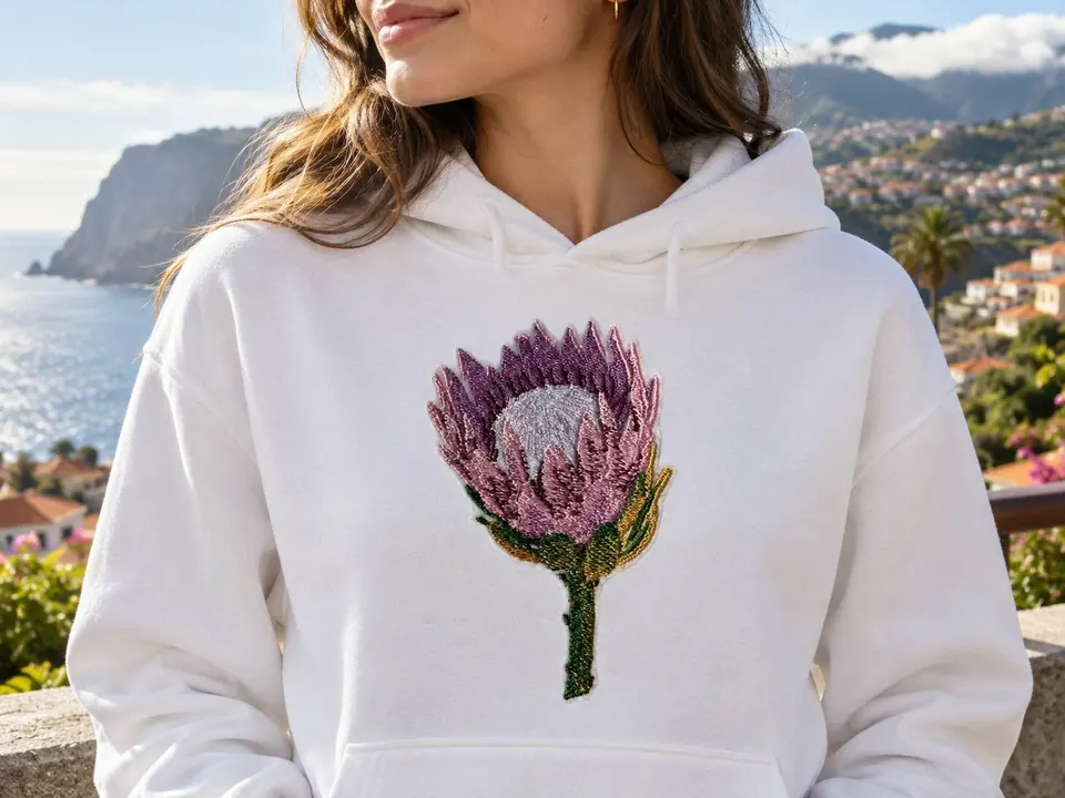 White hoodie embroidered with a protea